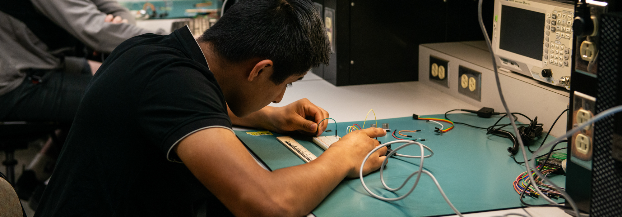 Student working on electronics in a lab
