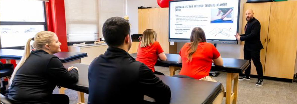 Student speaking during a classroom discussion with peers listening