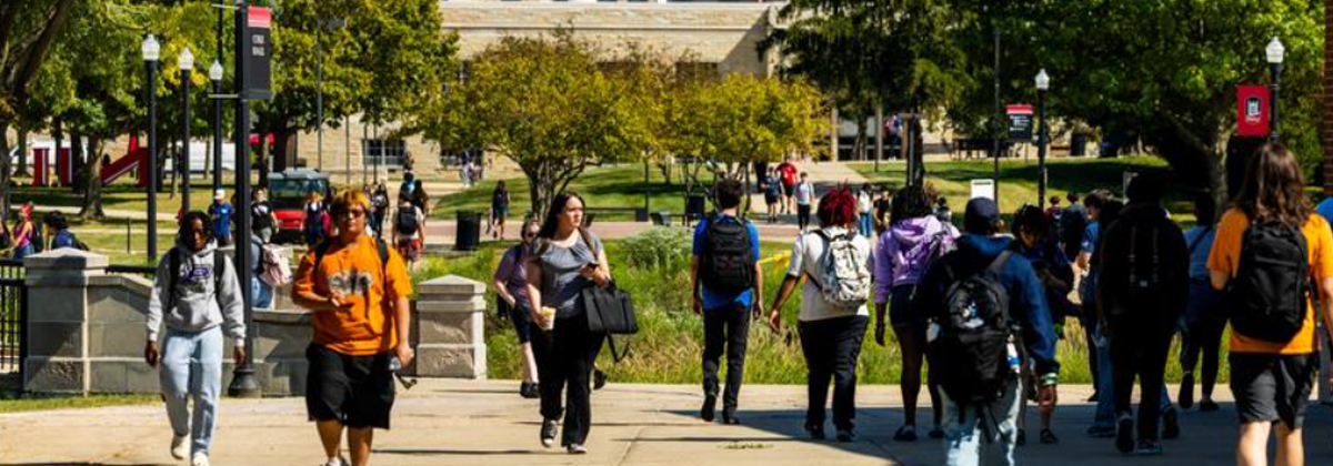 Students walking across a college campus between classes